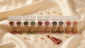 Sona Gold Traditional Lotus Motif Jhumka Earrings with Colorful Hanging Beads